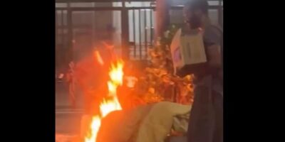 Moradores de rua acendem fogueira para cozinha em plena Av. Atlântica